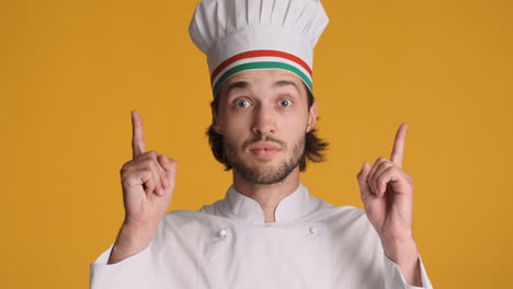 caucasian man in front of camera on yellow background.