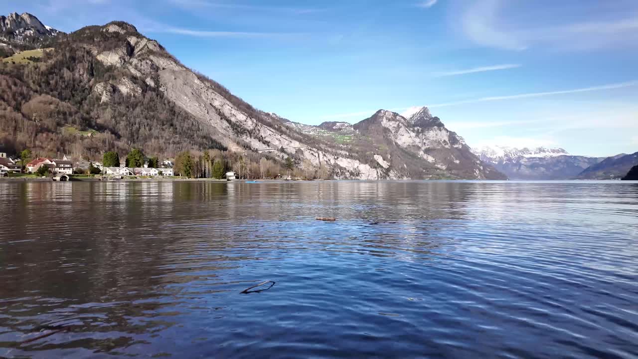 Mesmerising view of Walensee lake, Switzerland- st gallen canton- quinten featuring village on shore | Whirl created by throwing a wood stick in water