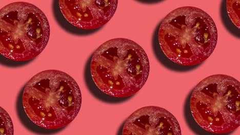 on a coral background, tomato slices are arranged in a geometric pattern. animation of a seamless loop motion graphic cuisine theme