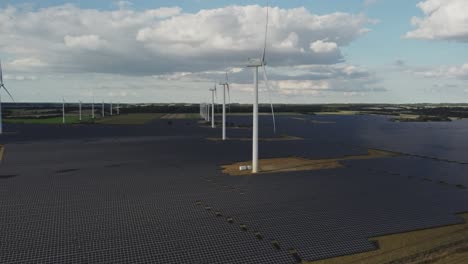 solar panels and wind turbines generating electricity at sustainable power station in vemb, denmark