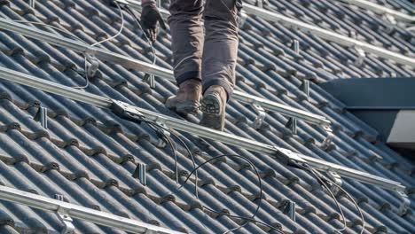 man climbing up roof on solar panel construction