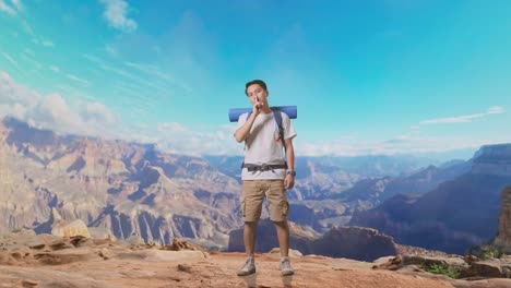 full body of asian male hiker with mountaineering backpack looking at camera and making shh gesture while traveling at the top of mountain