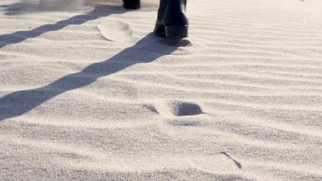 ultra slow motion close up shot of boots walking on sand in death valley national park in california, usa