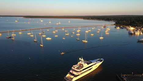 aerial view of luxury boats and marina at sunset, the hamptons