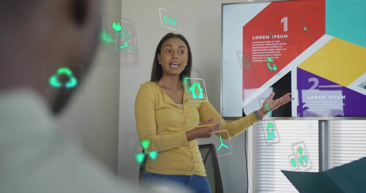 Donna che usa un tablet per avviare le diapositive 1-2, conduce una riunione di lavoro gesticolando con icone AR verdi fluttuanti.