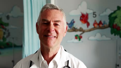 portrait of male doctor standing in ward