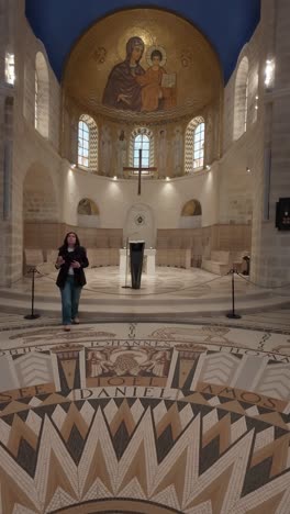 woman taking photos in sacred christian landmark. slow motion.
