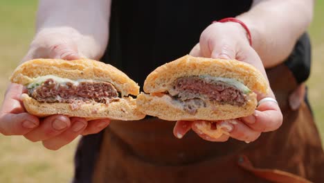 A-hamburger-in-half-sliced-being-presented-while-the-sauce-is-dripping