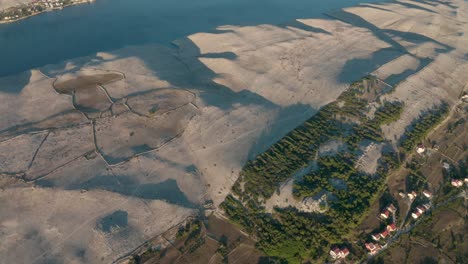 the peaceful adriatic landscape of croatia with homes by a small forest edge - aerial shot