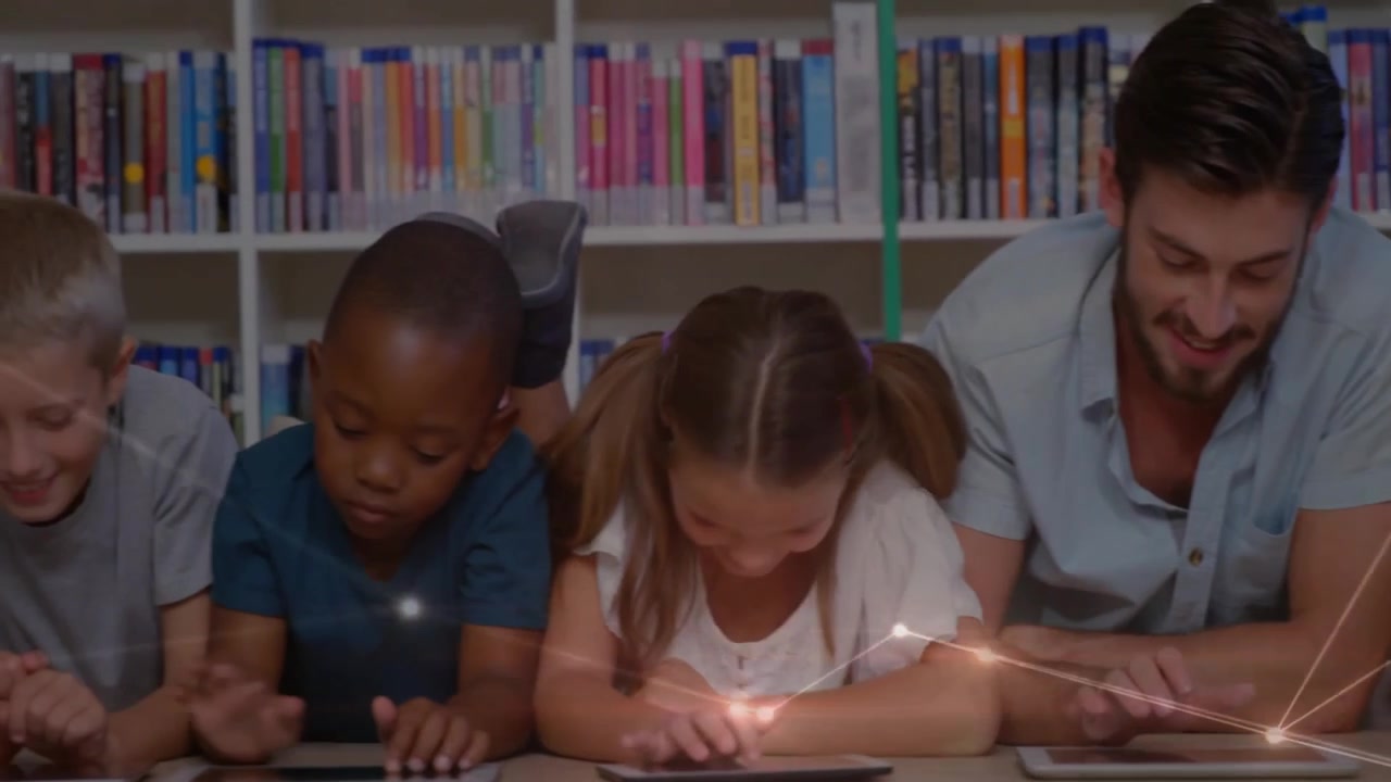 Teacher and children placing and tapping tablets for education in library, network overlay glowing