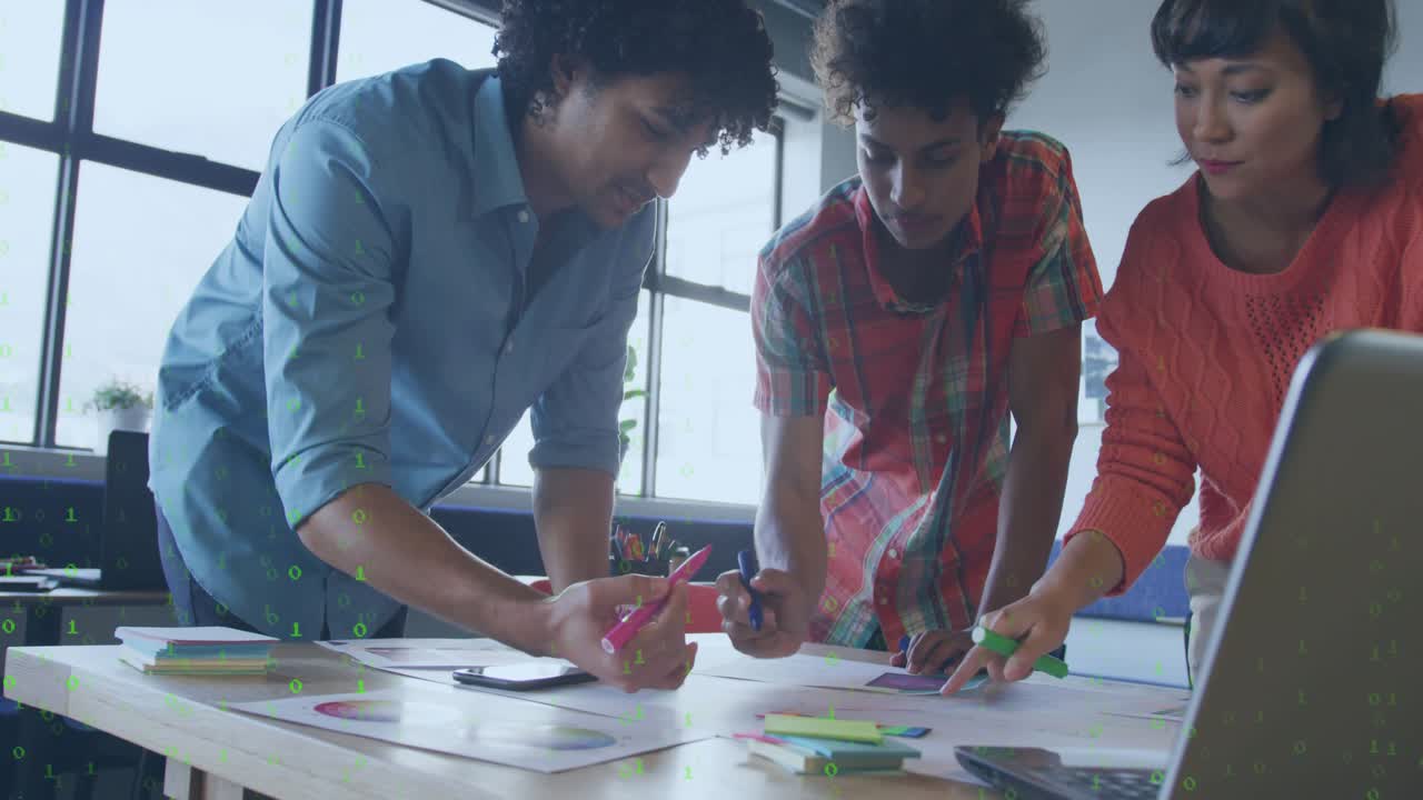 Team of three reviewing charts for design, highlighting in pink, green overlay fading on papers