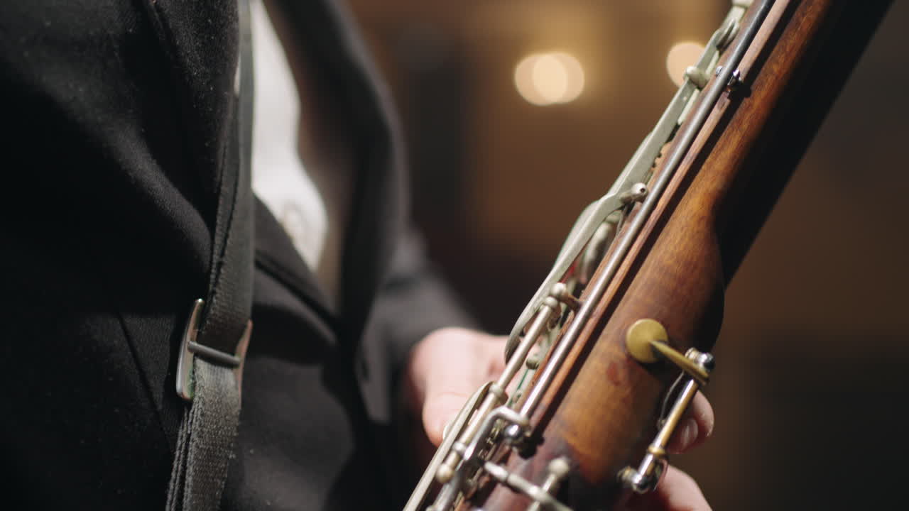 old bassoon in hands of musician closeup view symphonic or brass orchestra talented bassoonist