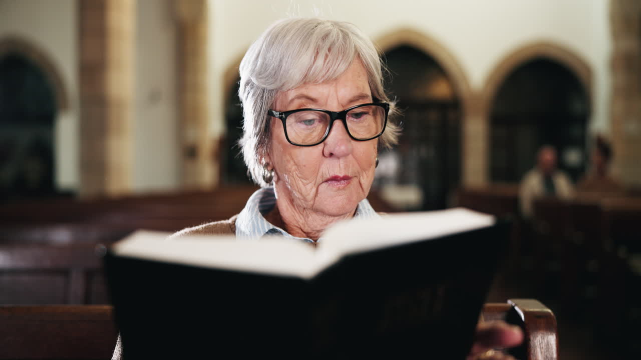 Senior woman reading prayer book in church