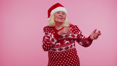 Senior-Christmas-old-grandmother-woman-listening-music-via-earphones,-dancing-disco,-fooling-around