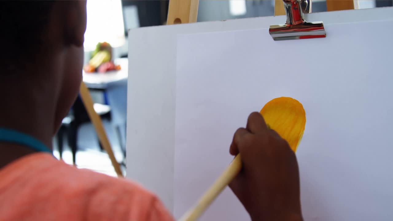 Attentive schoolboy panting on canvas
