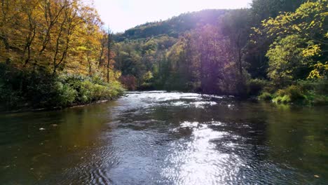 low angle sweeping shot of the new river in watauga county nc, north carolina