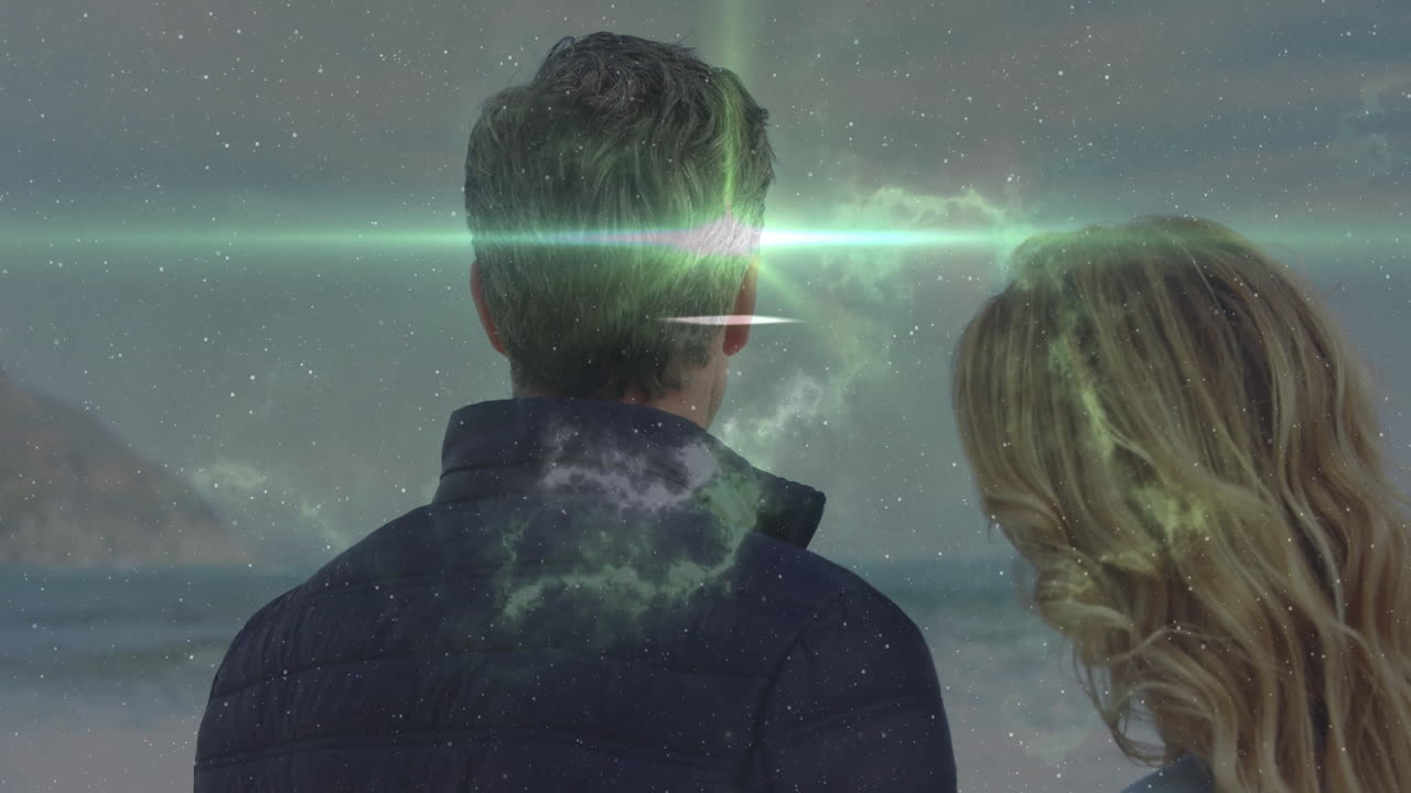 Man and woman looking at aurora borealis animation over night sky