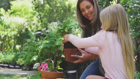 mother and daughter are replanting in the garden