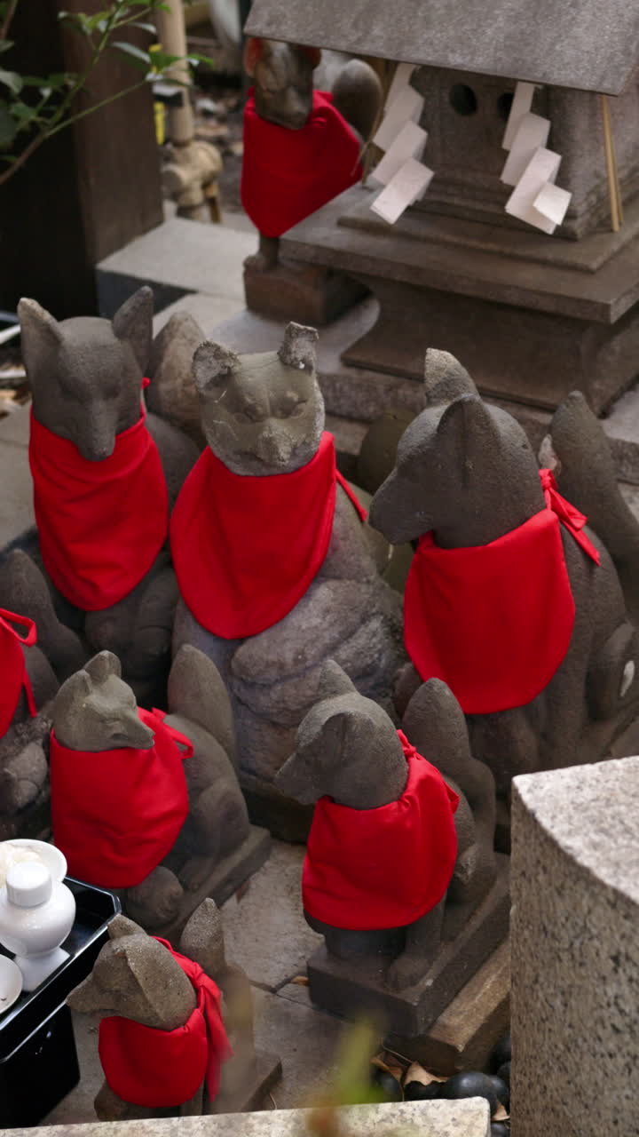 Close up of multiple Japanese fox statues. Vertical