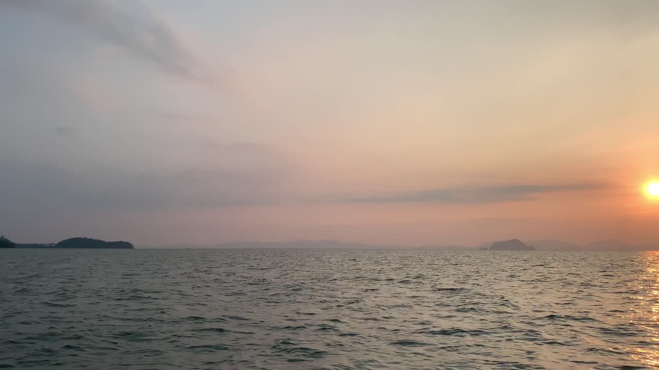 Landscape view of the sea ocean in early morning with sunrise in summer daytime while on the moving boat
