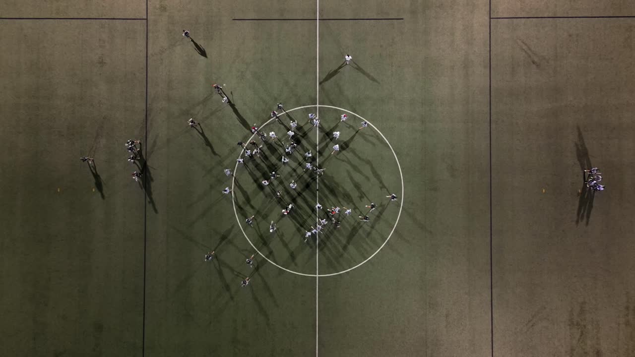 Lacrosse Team Breaks Huddle at Night Practice under Lights