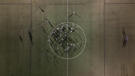 lacrosse team breaks huddle at night practice under lights
