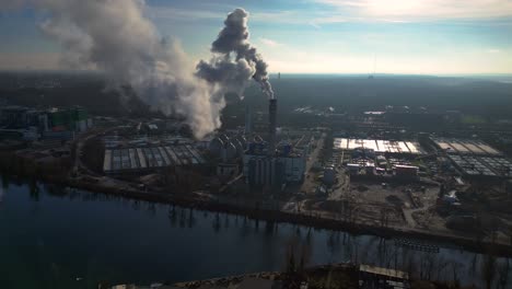 industrial plant with smoke stack and river