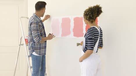 young couple debating a new paint color