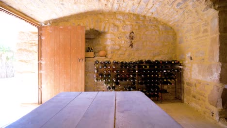 slow pull-out shot of a wine cellar filled with various bottles of wine