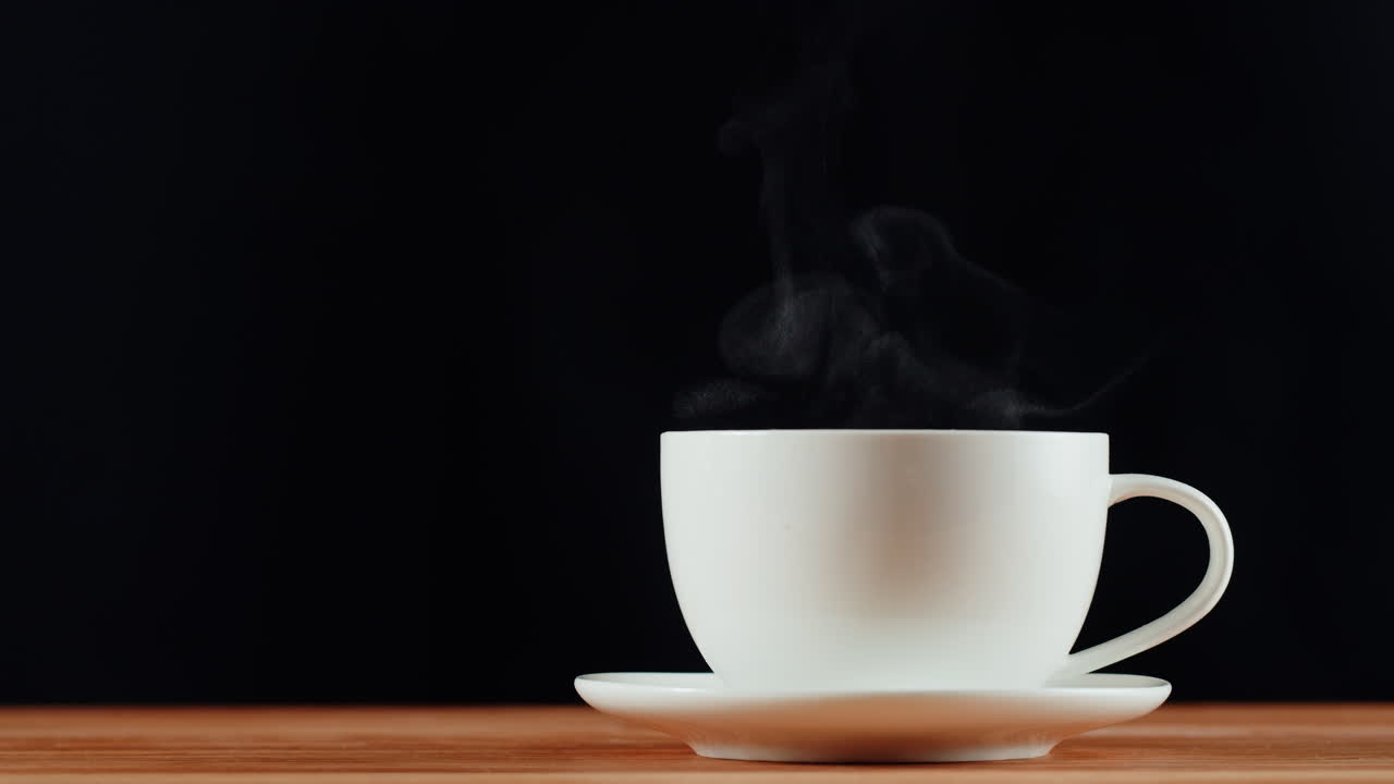 Steaming White Coffee Cup on a Wooden Table
