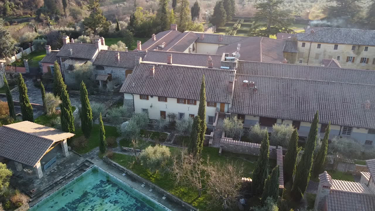 Aerial of CasaMora 18th century agriturismo and homestead in the amazing Florence surrounding hills. Winter season at sunset, Tuscany Italy