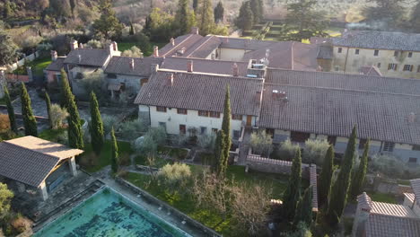 aerial of casamora 18th century agriturismo and homestead in the amazing florence surrounding hills. winter season at sunset, tuscany italy