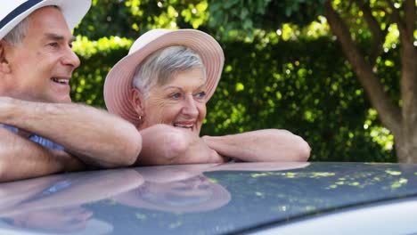 Senior-couple-leaning-on-car