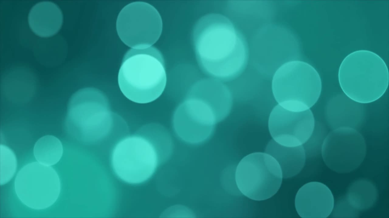 Luci bokeh astratte color verde acqua in movimento e scintillanti.