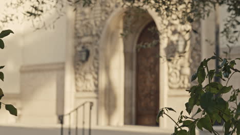 static shot of the very detailed and intricate entrance to the church that then goes out of focus