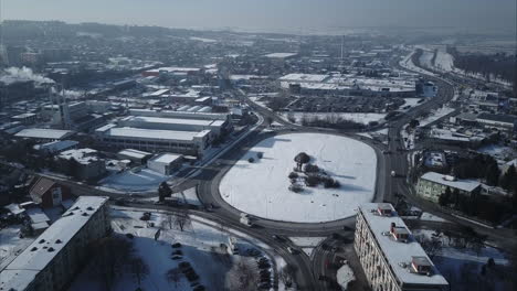 Flying-towards-big-roundabout-in-Nitra-City,-Winter,-Aerial-shot,-Slovakia