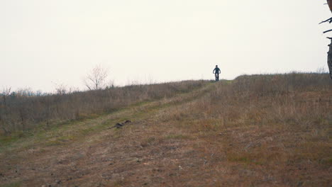 ciclista masculino atleta andando de bicicleta de montanha descendo a colina