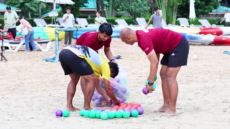 people organizing beach balls