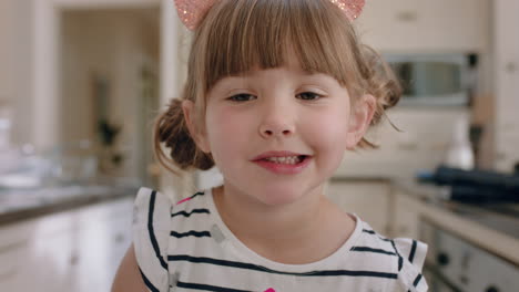 portrait beautiful little girl smiling waving hand looking at camera wearing cat ears
