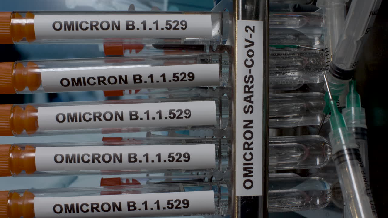 A close up vertical video of a medical professional wearing surgical gloves removing test tubes containing Omicron samples from a laboratory rack, the latest strain of Covid 19 found in South Africa
