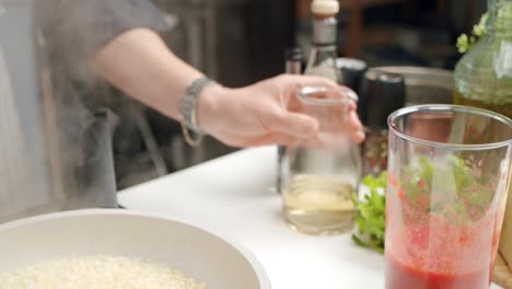 crop woman preparing risotto in kitchen