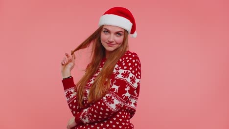 cheerful lovely girl wears red christmas sweater and hat smiling looking at camera happy new year