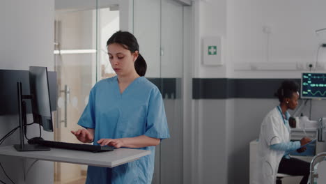 Front-view-of-assistant-typing-medical-expertise-on-computer