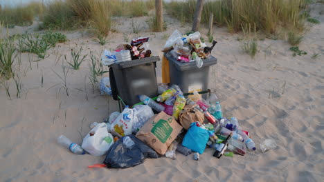 overflowing garbage bins on a beach accumulate more and more waste, highlighting a problem of environmental pollution due to poor waste management