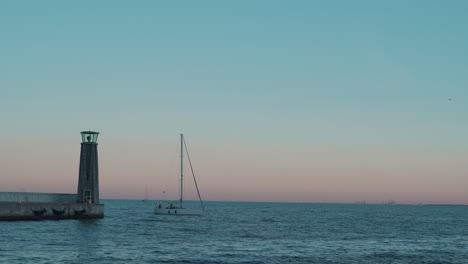 yacht sailing into the bay on the baltic sea at the sunset in gdynia