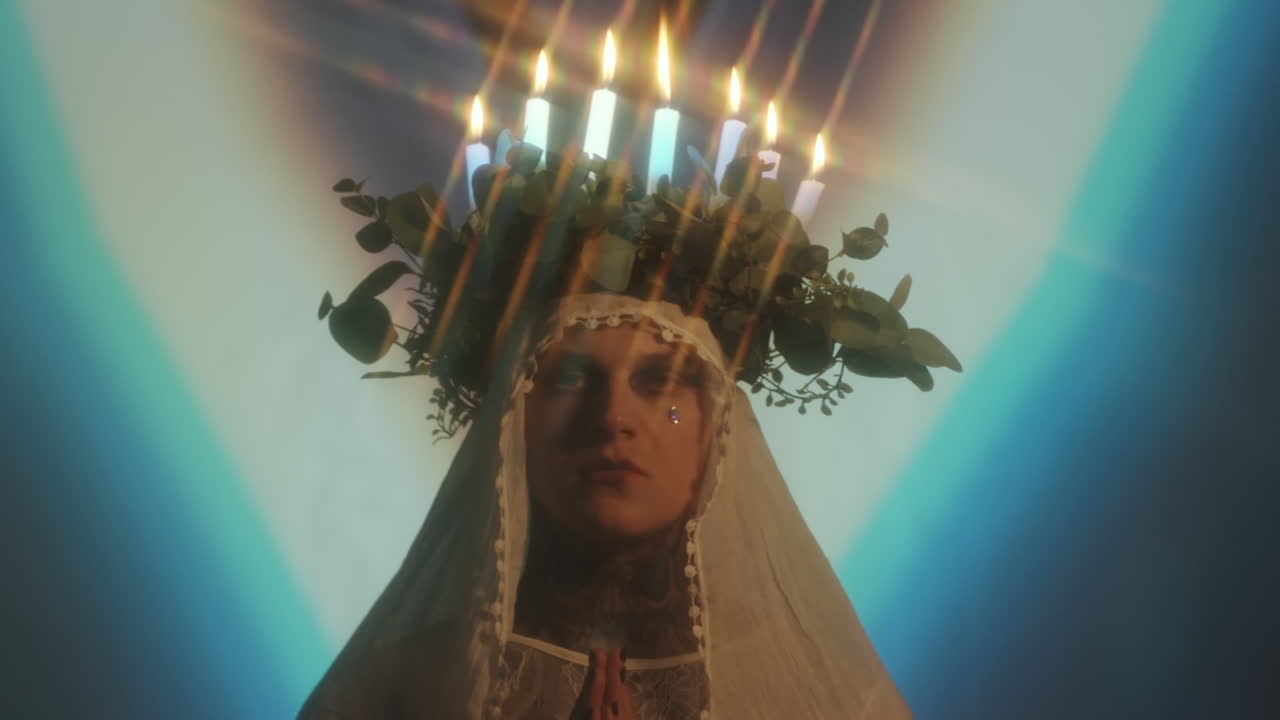 Man with Candle Lit Wreath and Hands Folded