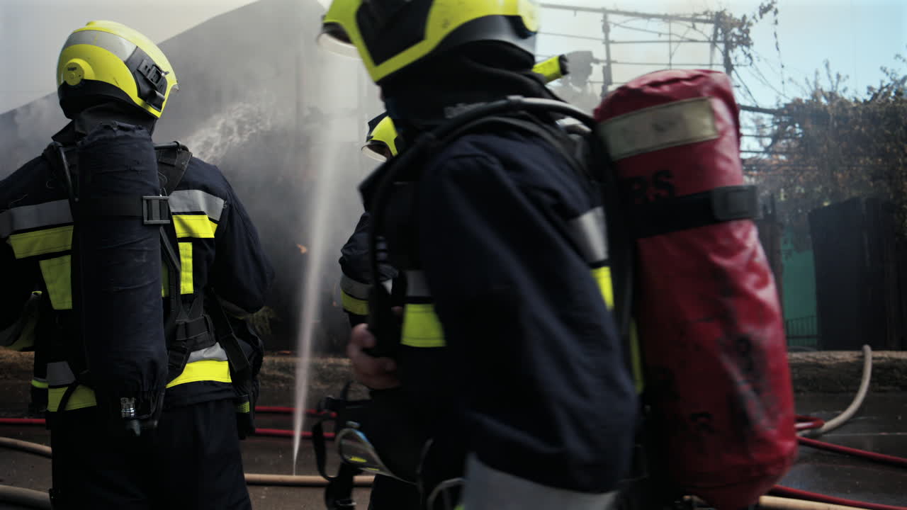 Firefighters trying to extinguish a house on fire