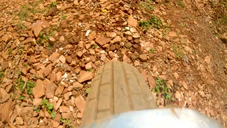 A-action-shot-of-a-motor-bike-wheel-driving-along-a-rocky-rural-road