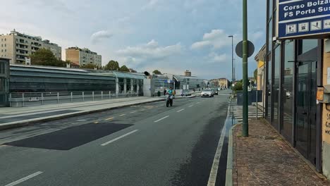 pedestrians and vehicles navigate a bustling street