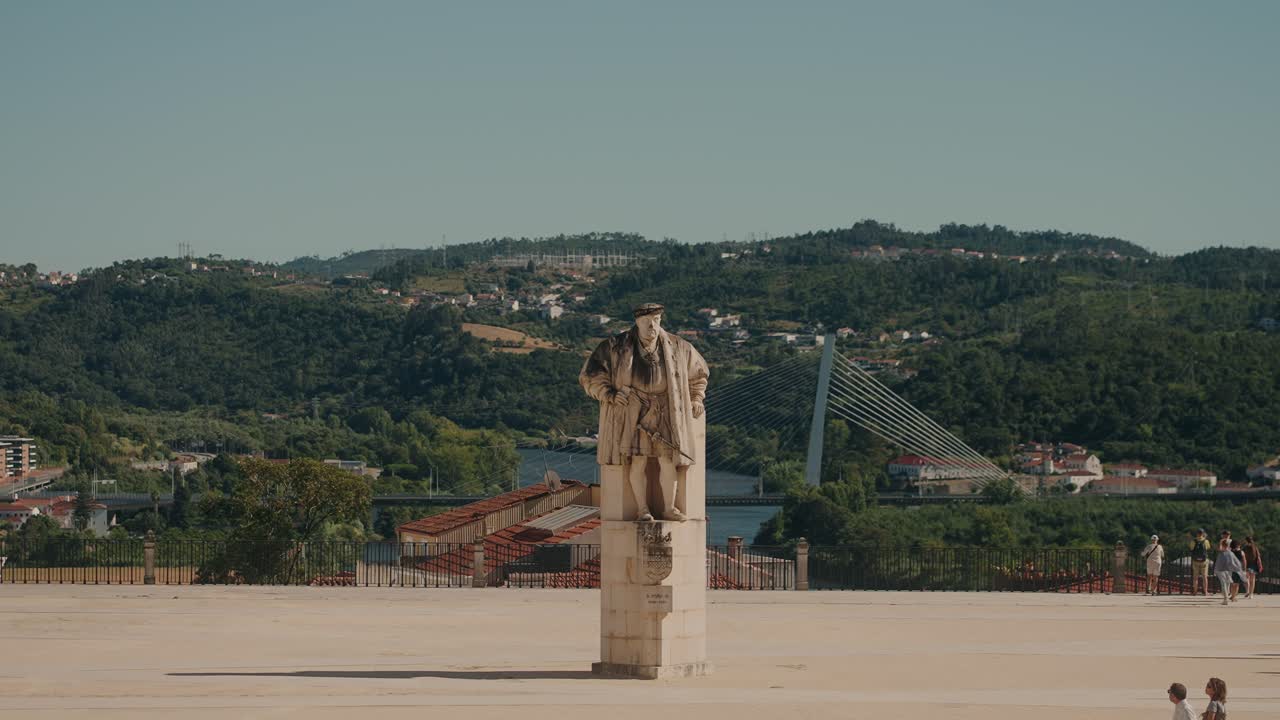 Statue overlooking a city and river